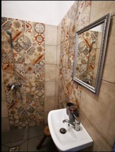 W łazience znajduje się umywalka i lustro. w obiekcie Őrség Kincse Nagy Apartman - 6 főre w mieście Hegyhátszentjakab