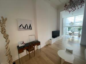 a living room with a table and a tv at Apartment in trendy Chatelain center Brussels area Little Garden Internet wifi in Brussels