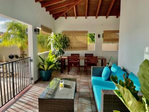 a living room with a blue couch and a table at Entire 4BDR Vistalmar Villa with Private Pool in Oranjestad
