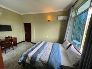 Postel nebo postele na pokoji v ubytování PHYLLEN HOTEL