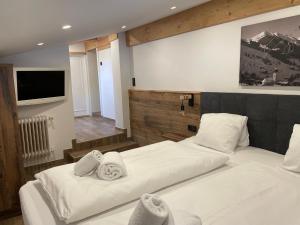 a bedroom with two beds with towels on them at Haus Willibald in Saalbach Hinterglemm