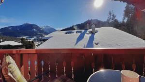 a snow covered roof of a house with a snow covered slope at Gästehaus Kurz in Berchtesgaden