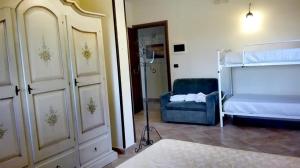 1 dormitorio con 1 cama y 1 silla azul en Agriturismo Santa Barbara, en Prignano Cilento