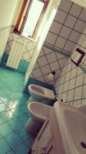 a bathroom with two toilets and a sink at Agriturismo Santa Barbara in Prignano Cilento +17 photos