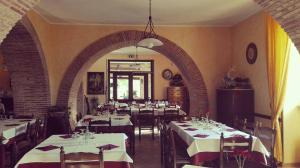 a dining room with tables and chairs and an archway at Agriturismo Santa Barbara in Prignano Cilento