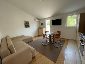 a living room with a couch and a table at Petros Apartments Pag in Pag