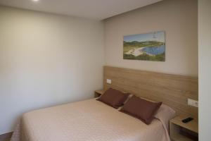 A bed or beds in a room at Apartamentos turisticos HAZ AMIGO