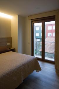 A bed or beds in a room at Apartamentos turisticos HAZ AMIGO