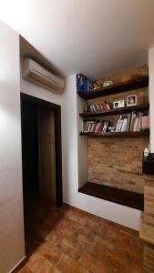 a room with a book shelf and a hallway at Appartamento country relax in Montelupone