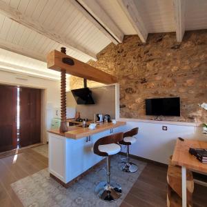 a kitchen with a counter with a sink and a tv at Casa de Casal in Lestedo