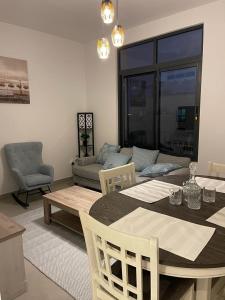 a living room with a table and a couch at Two Bedroom Beach residence in Sharjah