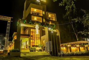 a building with christmas lights in front of it at Hotel Manasi INN in Satara