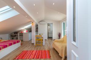 a bedroom with a bed and a kitchen with a table at Apartmani Lejla in Poljica