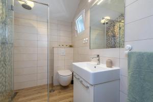 a bathroom with a sink and a toilet and a shower at Apartmani Lejla in Poljica +21 photos
