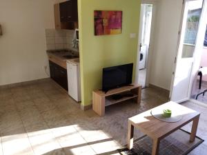 a living room with a tv and a table at Apartment Buic in Pula