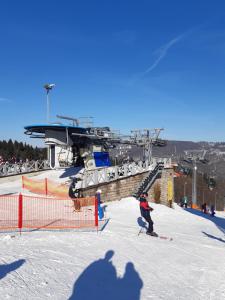 a group of people skiing on a ski lift at Ubytování U Janičky in Klíny