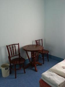 
two chairs and a table in a room at JJ. Home in Phetchaburi
