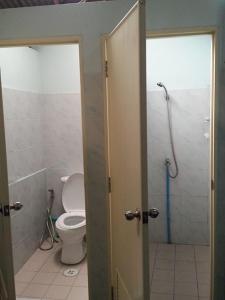 
a bathroom with a toilet and a shower stall at JJ. Home in Phetchaburi
