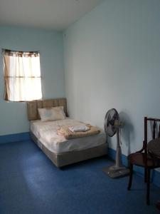 
a bedroom with a bed and a lamp at JJ. Home in Phetchaburi
