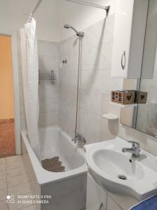a bathroom with a bath tub and a sink at TamarHouse Sperlonga Casa Noemi in Sperlonga +18 photos