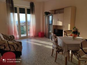 a living room with a table and chairs with a view at TamarHouse Sperlonga Casa Noemi in Sperlonga