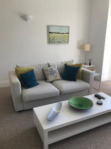 a living room with a couch and a coffee table at Tree Tops Apartment in Tunbridge Wells in Royal Tunbridge Wells