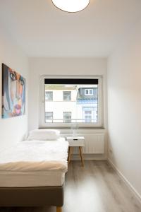 a bedroom with two beds and a window at ☆ Modern stylish flat in central location in Wilhelmshaven