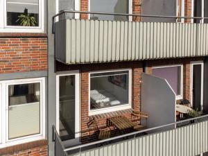 a brick building with windows and a balcony at ☆ Modern stylish flat in central location in Wilhelmshaven