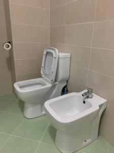 a bathroom with a toilet and a sink at Eri Apartments 4 in Shëngjin