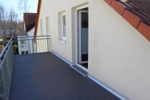 a balcony of a house with a door open at Ferienapartment Alma in Erfurt