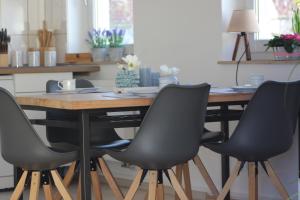 a dining room table with four chairs around it at Ferienapartment Alma in Erfurt +14 photos
