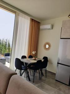 a dining room with a table and chairs and a refrigerator at Villa Amal Palase in Palasë +14 photos
