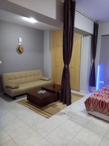 a living room with a couch and a coffee table at Old Town studio apartment in Larnaka