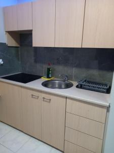 a kitchen with a sink and a counter top at Old Town studio apartment in Larnaka