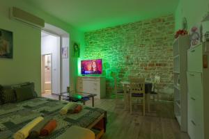 a green living room with a brick wall at Rich apartment in Pula