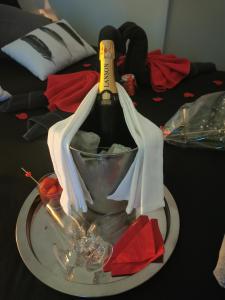 a bottle of wine on a plate on a table at Jacuhomespa13 in Vitrolles