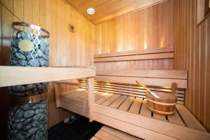 a wooden sauna with a wooden bucket in it at Ruka Villa Kieppi in Ruka