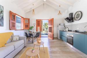 a kitchen and living room with a couch and a table at Bungalow Sonia in Cadet