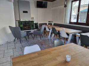 a restaurant with tables and chairs and a fireplace at Hotel PlannerInn in Planneralm