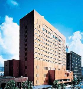 a tall building in a city with at Hotel Grand Terrace Toyama in Toyama