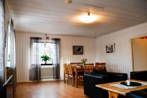 a dining room with a table and chairs at Villa Sjöhästen in Grangärde
