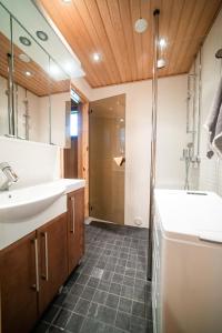 a bathroom with a sink and a shower at Ruka Villa Kieppi in Ruka