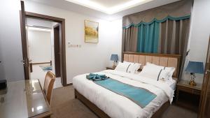 Postel nebo postele na pokoji v ubytování مواسم للأجنحة الفندقية