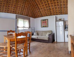 a living room with a table and a couch at Finca el Abuelo Manuel in Vejer de la Frontera