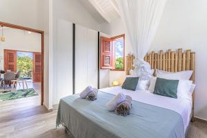 En eller flere senge i et værelse på Bungalow Damien