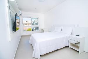 Ένα ή περισσότερα κρεβάτια σε δωμάτιο στο Apto. 3 dorm. entre Praia da Cal e Lagoa Violão