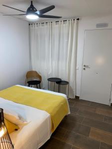 
a bedroom with a bed and a desk at Pension Rovior in Calafell
