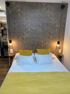 
a bed with a white bedspread and pillows at Pension Rovior in Calafell
