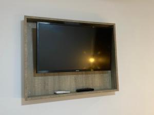 
a tv mounted to a wall in a room at Pension Rovior in Calafell
