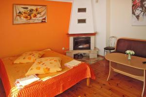 a bedroom with a bed and a table and a fireplace at holiday home, Kolczewo in Kołczewo